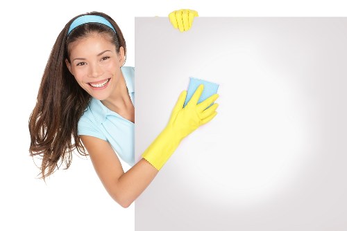 Technician treating stains during mattress cleaning in NW8