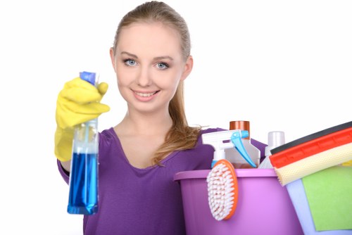 Cleaner making a bed in a furnished NW8 apartment