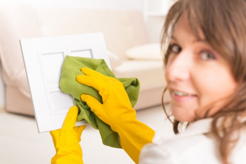 Local window cleaner working on upper-floor windows in NW8