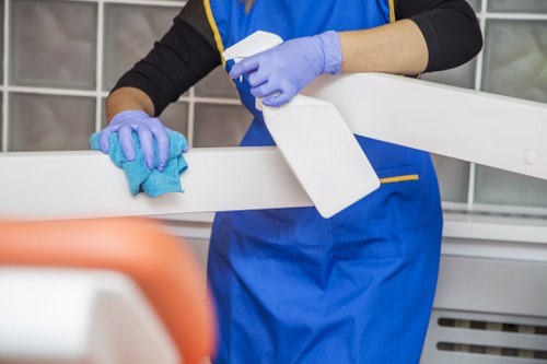 Professional cleaner maintaining a retail premises in NW8